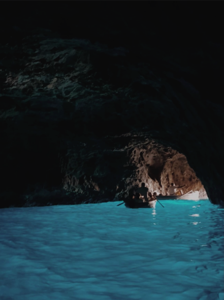 The Blue Grotto glowing blue inside the sea cave on Capri