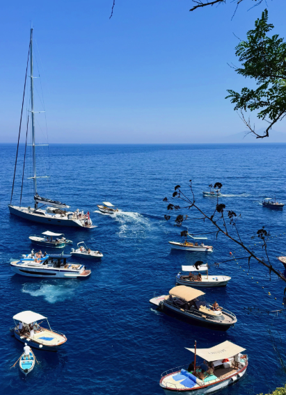 Boats moored below the cliffs of Capri island